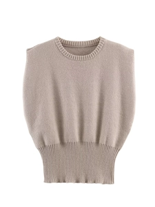 Macro detail of the round neckline and ribbed texture on the light brown knitted vest