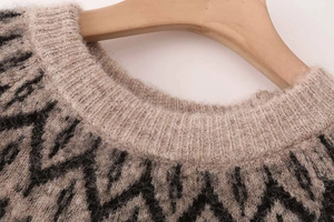 Detailed view of the ribbed crew neckline and soft knit fabric of the brown sweater