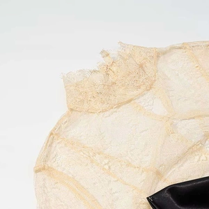 Elegant sleeveless lace dress with satin detail and intricate floral neckline patterns