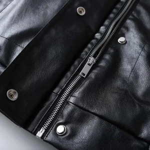 Women's black faux leather jacket with metal zippers and textured grain finish