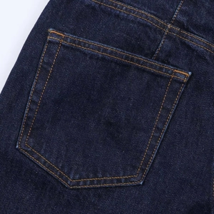 Detailed close-up of dark blue denim rear pockets with contrast yellow double-stitch seams