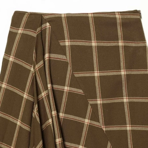 Brown and green plaid asymmetrical mini skirt with high waist and cream check pattern