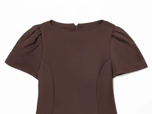 Detail of dark brown dress featuring puff sleeves and boat neckline with back zipper