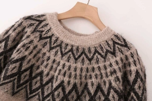 Detailed view of the crew neck and geometric diamond knit pattern on this vintage sweater