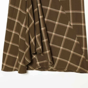 Women's summer plaid skirt featuring brown checkered pattern and asymmetric ruffled hemline
