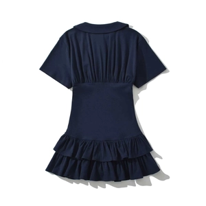 Detail view of navy blue dress featuring pleated bodice and ruffled layered hemline