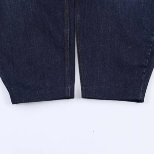 Detail of dark blue denim hem featuring high-quality orange double-row stitching