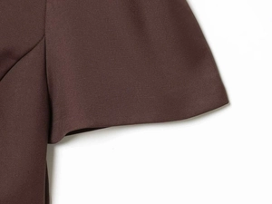 Detail of deep brown woven fabric showing fine twill texture and neat stitching detail