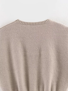 Detail of oatmeal knitted tank top showing fine ribbing on the crew neckline and shoulder