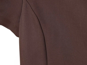 Macro detail of dark brown dress fabric showing twill weave texture and stitching