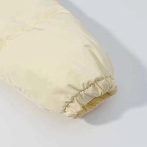 Detail of the elastic windproof cuff on this beige padded puffer jacket for women
