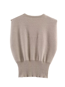 Detail view of earth-toned knit vest featuring fine texture and ribbed waistband hem