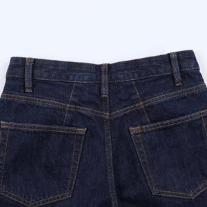 Detail view of dark blue denim jeans featuring back pockets and yellow contrast stitching