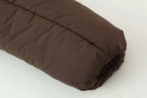 Detailed macro view of dark brown padded sleeve cuff with high-quality quilted stitching
