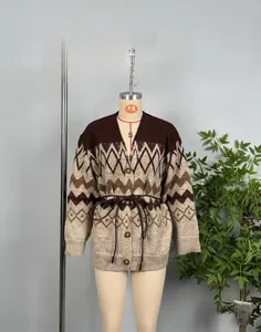 Detail view of vintage jacquard knit cardigan with wave pattern and brown leather belt