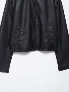 Detail of a black faux leather jacket with side pockets and smooth lychee texture finish