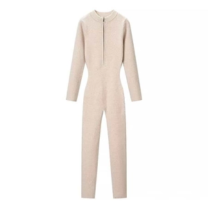 Women's beige ribbed knit jumpsuit with long sleeves and front half-zipper closure