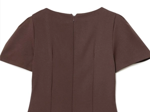 Detail view of deep brown dress with puff sleeves, back invisible zipper and darted waist