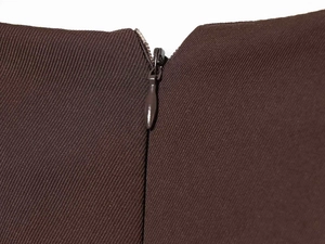 Detail of the invisible zipper and high-quality dark brown twill fabric on the dress
