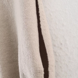 Women's loose sleeveless knit vest in oatmeal color with stylish side split details