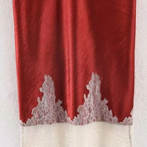 Elegant red satin midi skirt featuring a delicate white lace hem for a stylish look