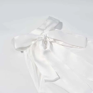 Elegant white satin strapless dress featuring a large decorative bow neckline