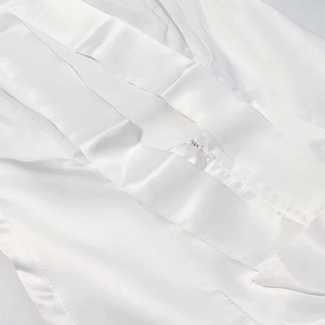 Close-up of white satin dress fabric texture with a high-quality invisible zipper detail