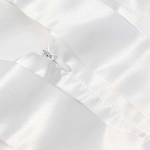 Detailed macro shot of white satin fabric showing the seamless concealed zipper design