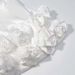 White strapless tube dress featuring detailed 3D satin rose flower texture and ruffle hem