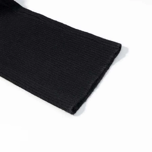Close-up of black ribbed knit cuffs showing high-quality texture and vertical weave pattern