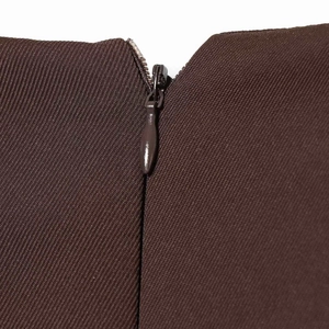 Close-up of deep brown puff sleeve dress with hidden zipper closure and twill texture
