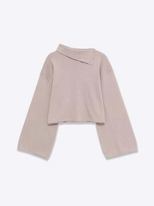 Close-up of soft knit sweater featuring asymmetrical fold-over collar and relaxed silhouette