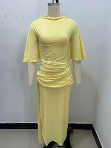 Detail of waist pleats and flared sleeves on light yellow backless maxi dress