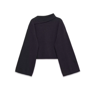 Detail of black knit top featuring a unique asymmetrical fold-over collar and texture