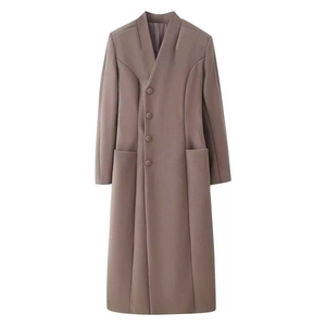 Detailed close-up of dark khaki wool coat featuring a collarless V-neck and button closure