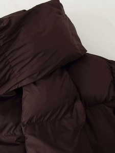 Détail d'une doudoune d'hiver marron foncé avec coutures et tissu de haute qualité