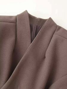 Detail shot of taupe wool coat collar featuring overlap design and smooth inner lining