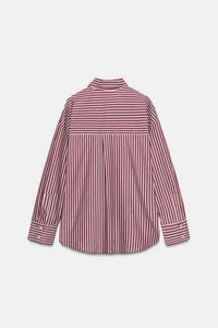 Detail view of the back box pleat and red pinstripe pattern on the cotton shirt