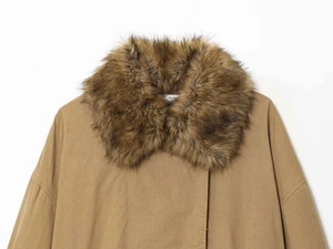 Detail of pilot jacket featuring thick brown faux fur collar and camel twill fabric