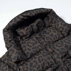 Quilted hooded puffer jacket featuring a dark leopard print with silver metal snap buttons