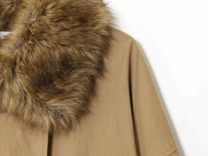 Close-up of fluffy brown faux fur collar on khaki twill cotton bomber jacket