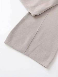 Detailed close-up of the fine knit texture and high-quality stitching of the grey sweater