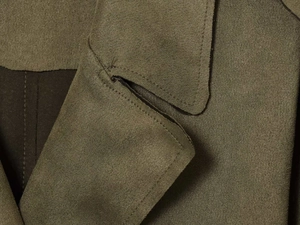 Macro shot of fine stitching and suede texture on military green trench coat lapel