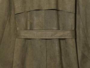 Close-up detail of olive green faux suede trench coat with stitching and waist belt