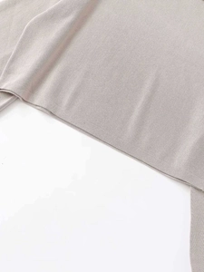 Detailed macro view of the soft taupe knitted fabric texture and fine hem stitching