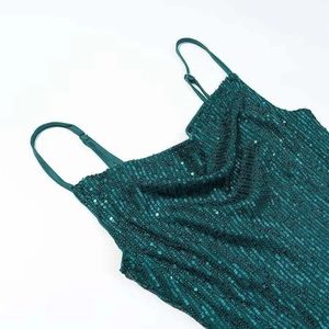 Dark green sequined slip dress with slim straps and a draped neckline on a white background