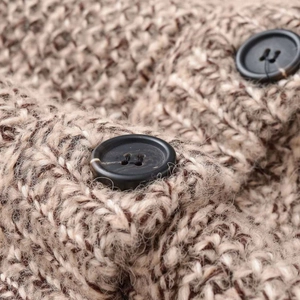 Close-up of women's warm brown mixed knit sleeveless top with chunky texture and buttons