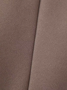 Detailed close-up of dark brown wool blend fabric texture with high-quality stitching seams