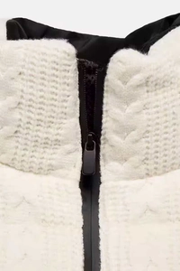 Close-up of cable knit ski jacket with black zipper and smooth dark lining