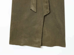 Detail shot of army green faux suede trench coat fabric with overlapped hem and tie belt